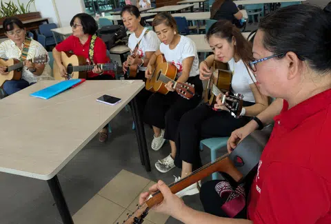 Ms Jetky Amores (right) teaches cooking classes, but says musical performances help to make new friends and are a lively atmosphere for learning.