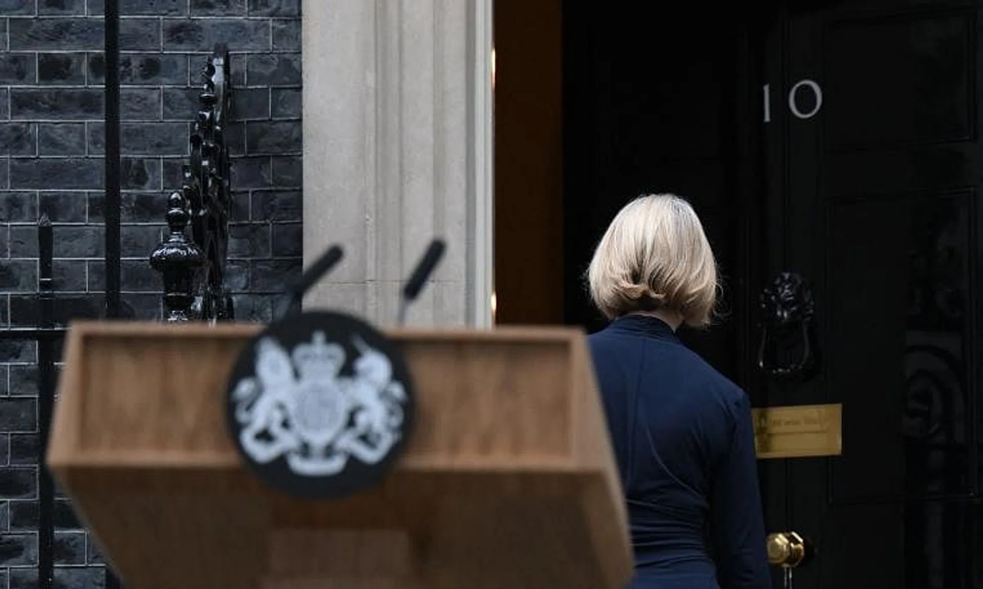 Britain's Prime Minister Liz Truss get inside 10 Downing Street, in central London, on Oct 20, 2022 following a statement to announce her resignation. 