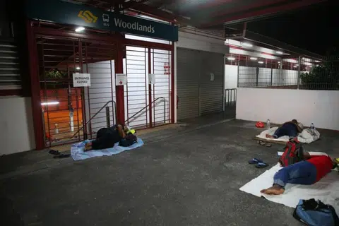 Having a shut-eye at Woodlands MRT station before their shift starts