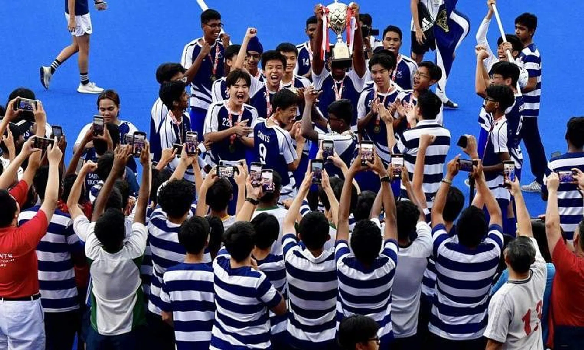 A jubilant St Andrew’s team celebrating with supporters and schoolmates after clinching the ‘B’ Division title on April 12.