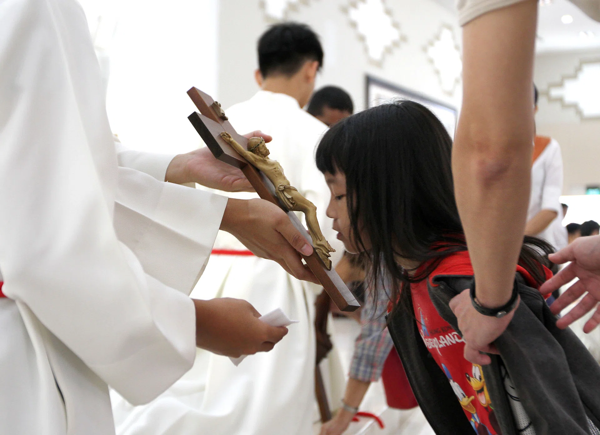 RESPECT: (Above) The Veneration of the Cross. Christians honour the cross by kneeling before it and kissing it.
