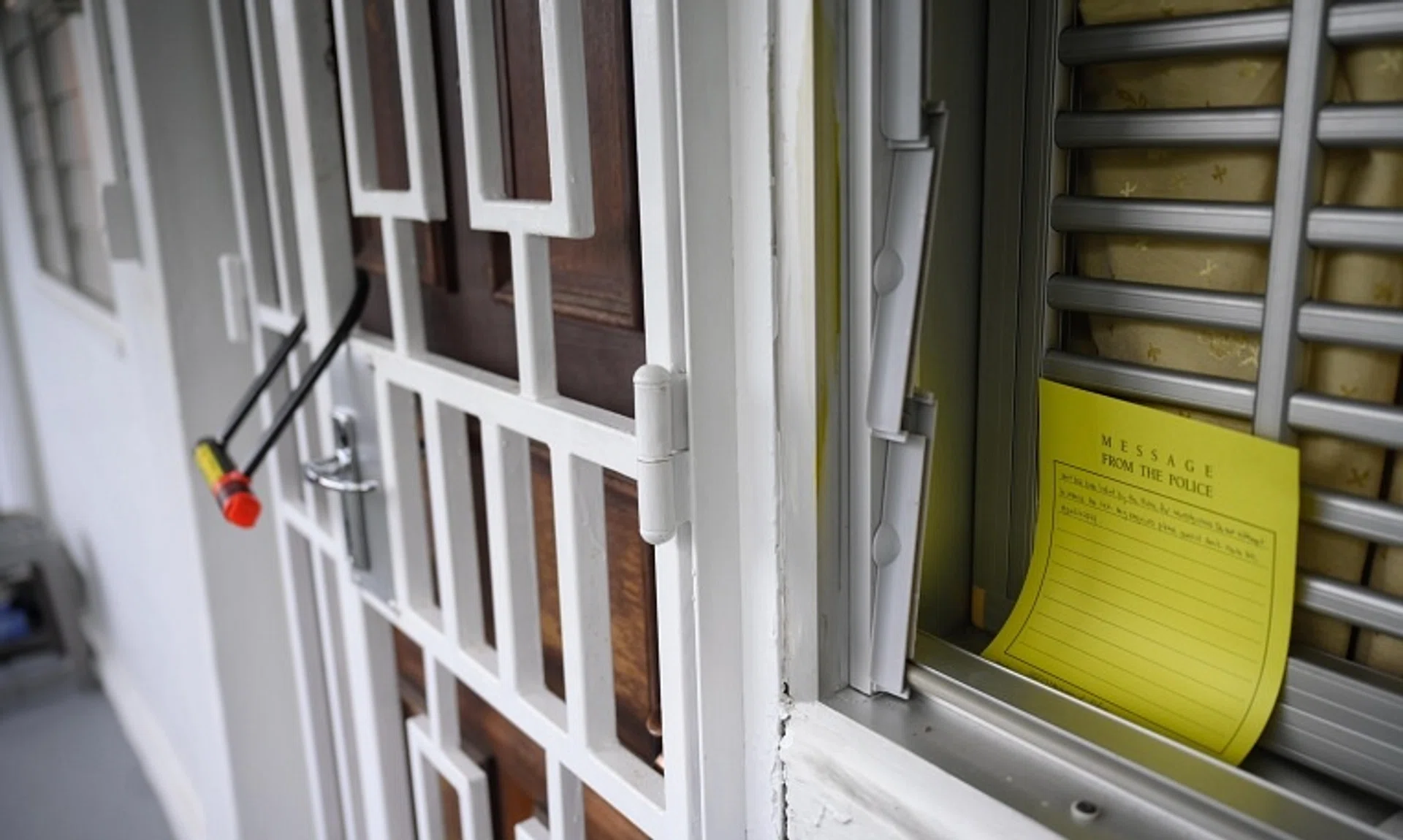 A note placed by the police instructing people not to remove the lock outside the unit at Block 125 Ang Mo Kio Avenue 6, where a 66-year-old man was arrested for suspected murder, on Nov 29.