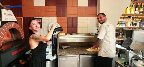 Ms Alessandra Gulino, co-owner and marketing manager of Fortuna, shooting a video of head chef Omar Tutino while he prepares a pizza.
