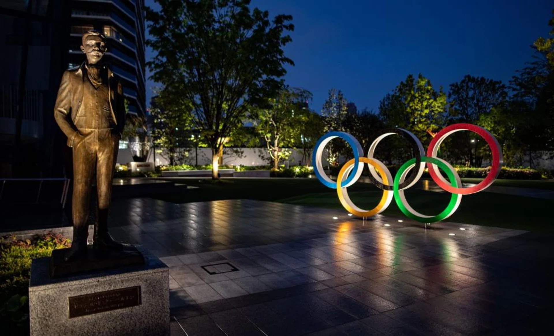 A bronze statue of Pierre de Coubertin, founder of the International Olympic Committee, and the Olympic Rings are displayed at Japan Sport Olympic Square in Tokyo.