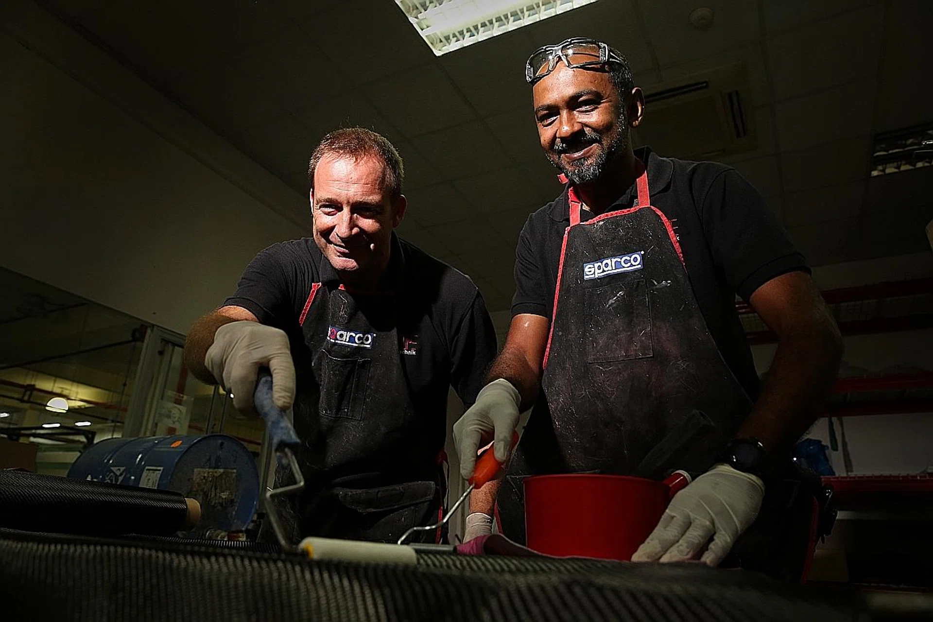 Mr Matthew Keith Wilkinson (left) and Mr Ashok Kumar working on a carbon fibre panel.