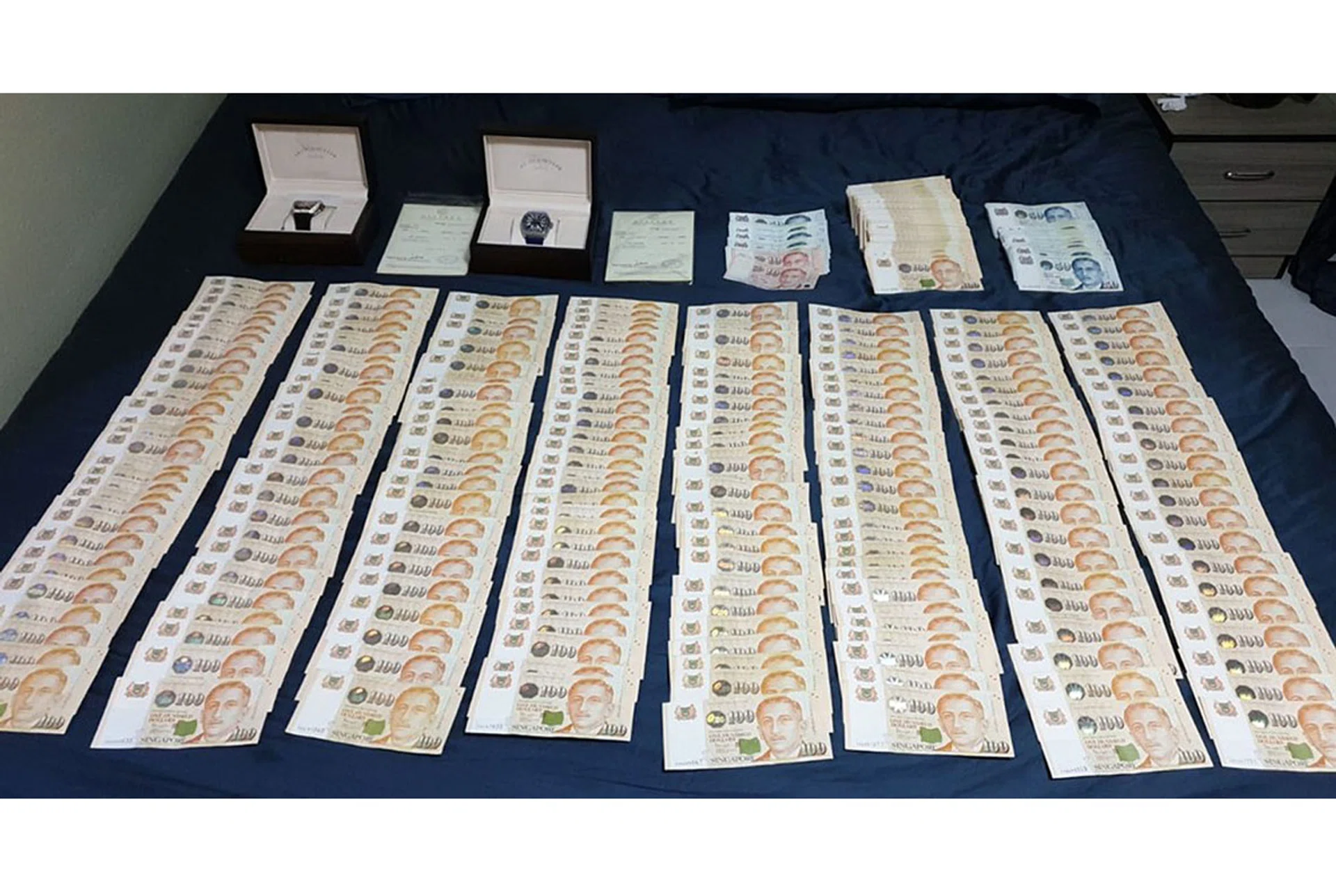 Proceeds recovered from Chee Jian Rong's home, after he allegedly duped a man into believing he had personal protection gowns to sell. 