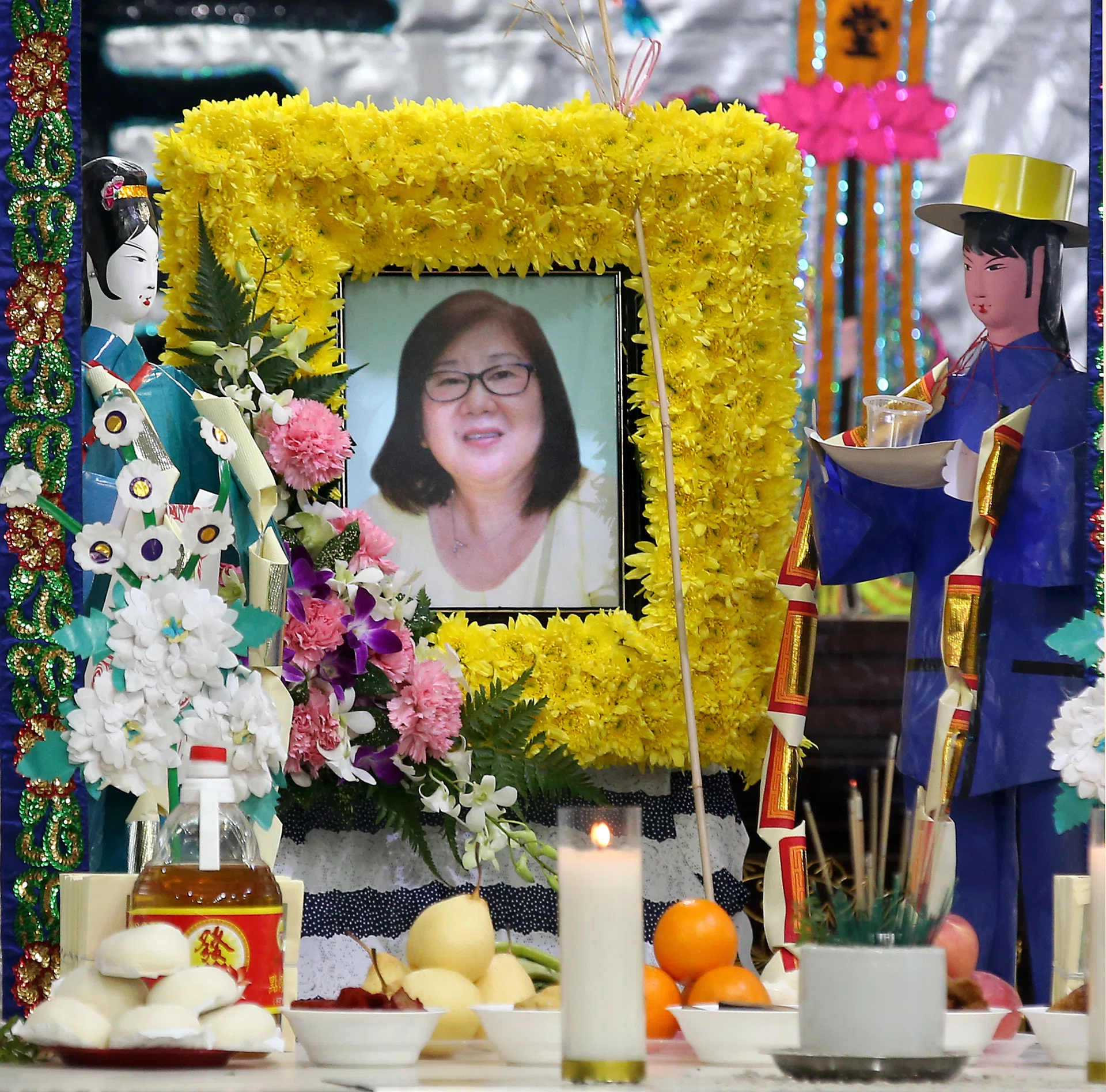 TRAGIC: Mr Goh Cherk Wui and his stepfather, Mr Cheng Kiat Yan, at Madam Tan Powi Kim’s (above) wake.