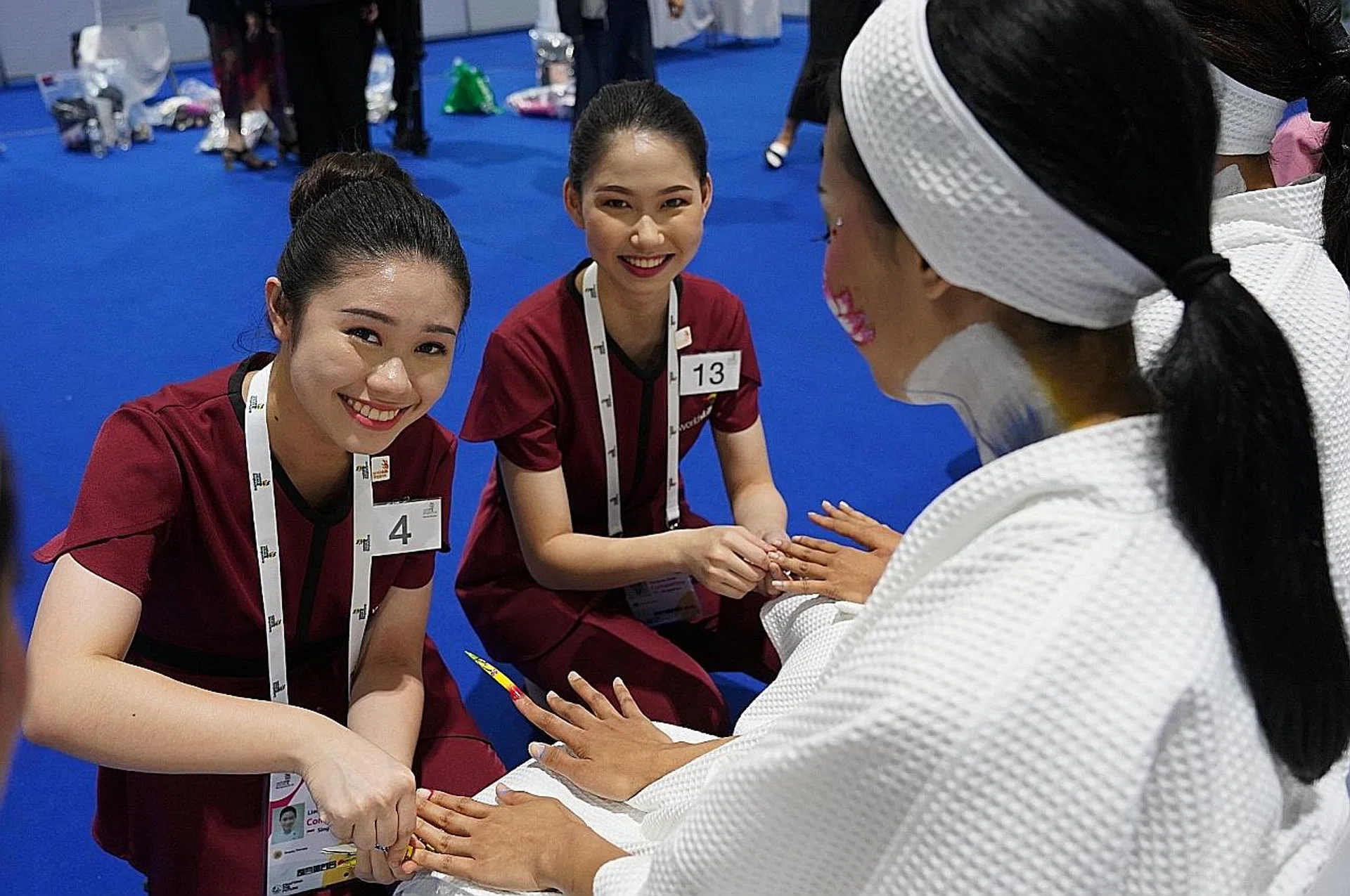 Miss Lim Hui Fang (left) won the gold medal for beauty therapy at the recent WorldSkills Asean competition held in Bangkok. Her coursemate, Miss Vanessa Kow (middle) bagged the silver medal in the same category. 
