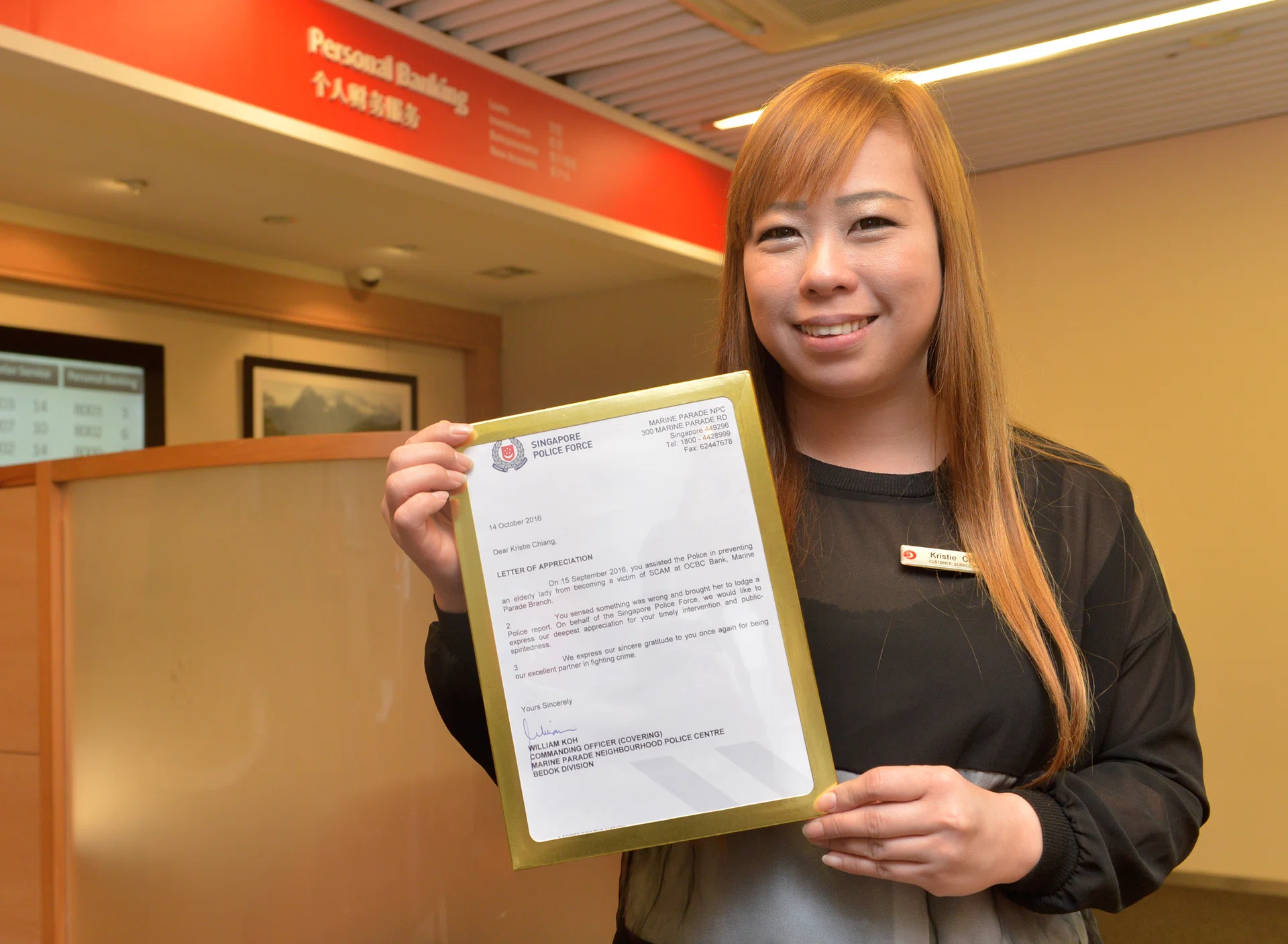 ALERT: Ms Kristie Chiang, customer service manager at OCBC Marine Parade branch, with the Letter of Appeciation. 
