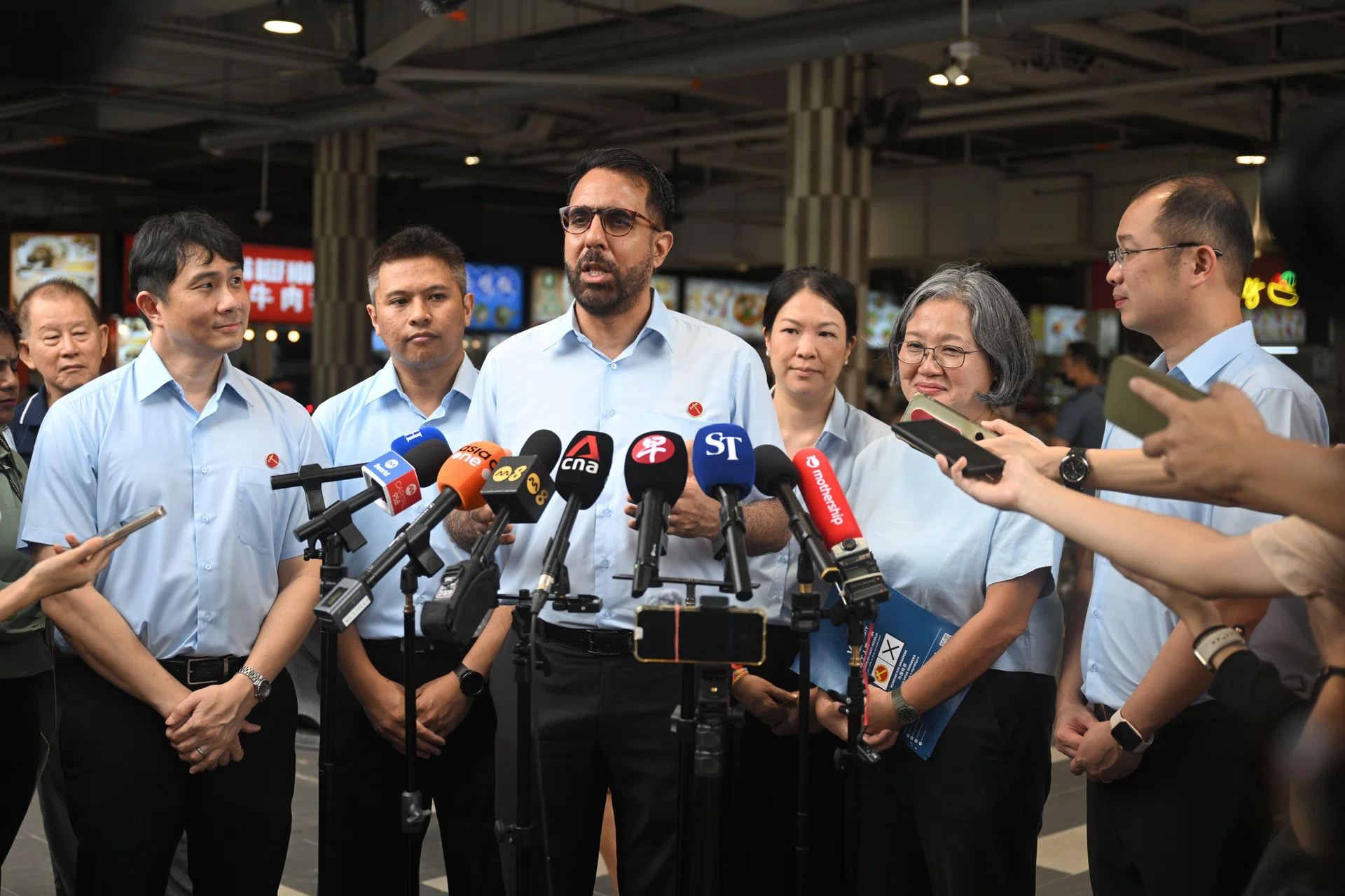 WP chief Pritam Singh (third from left) speaking to reporters after a walkabout in Sengkang on April 24. With him are WP chair Sylvia Lim (second from right) and the party's Sengkang GRC candidates (from left) Jamus Lim, Abdul Muhaimin Abdul Malik, He Ting Ru and Louis Chua.