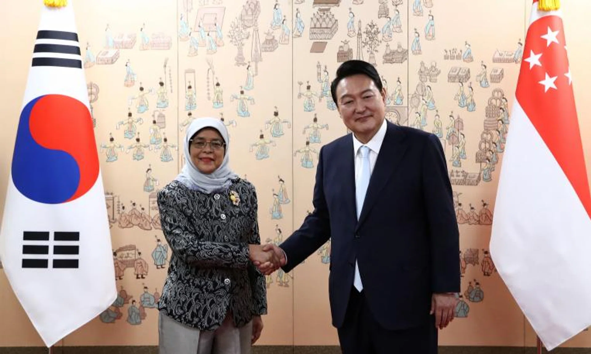 President Halimah Yacob (left) and South Korea's President Yoon Suk-yeol meet after his inauguration ceremony in Seoul on May 10, 2022.