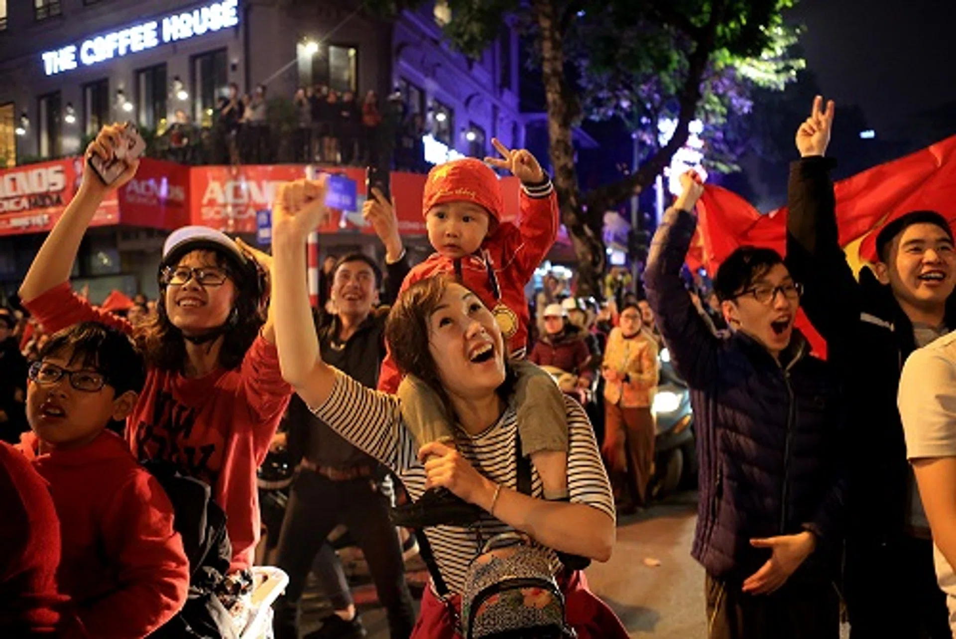 Vietnam's football fans celebrate in Hanoi after the country's U-23 team beat Iraq in a quarter-final of the AFC U23 Championship. Vietnam won 5-3 on penalties.