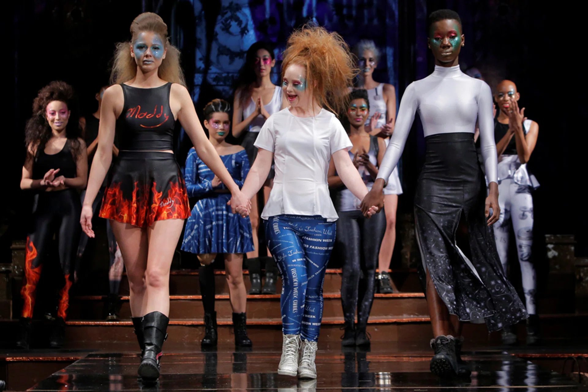 Australian model and designer Madeline Stuart, who has Down syndrome, acknowledges attendees after presenting creations from her label 21 Reasons Why By Madeline Stuart during New York Fashion Week