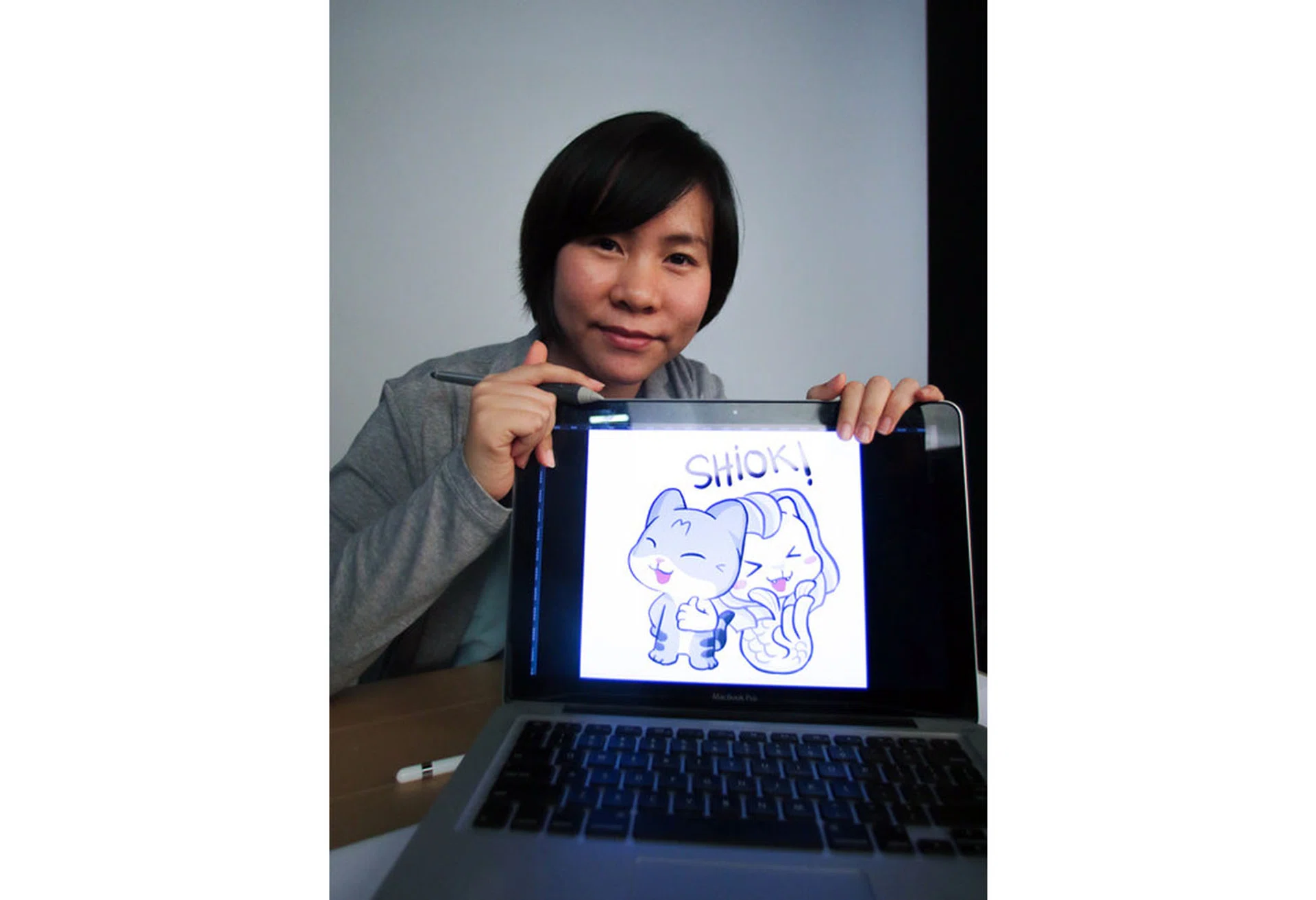 CUTE CREATION: Miss Dira Gana Mahata with one of the stickers for Meow The Tabby Cat. PHOTO: MOHAMED FIRDAUS AL-AMIN