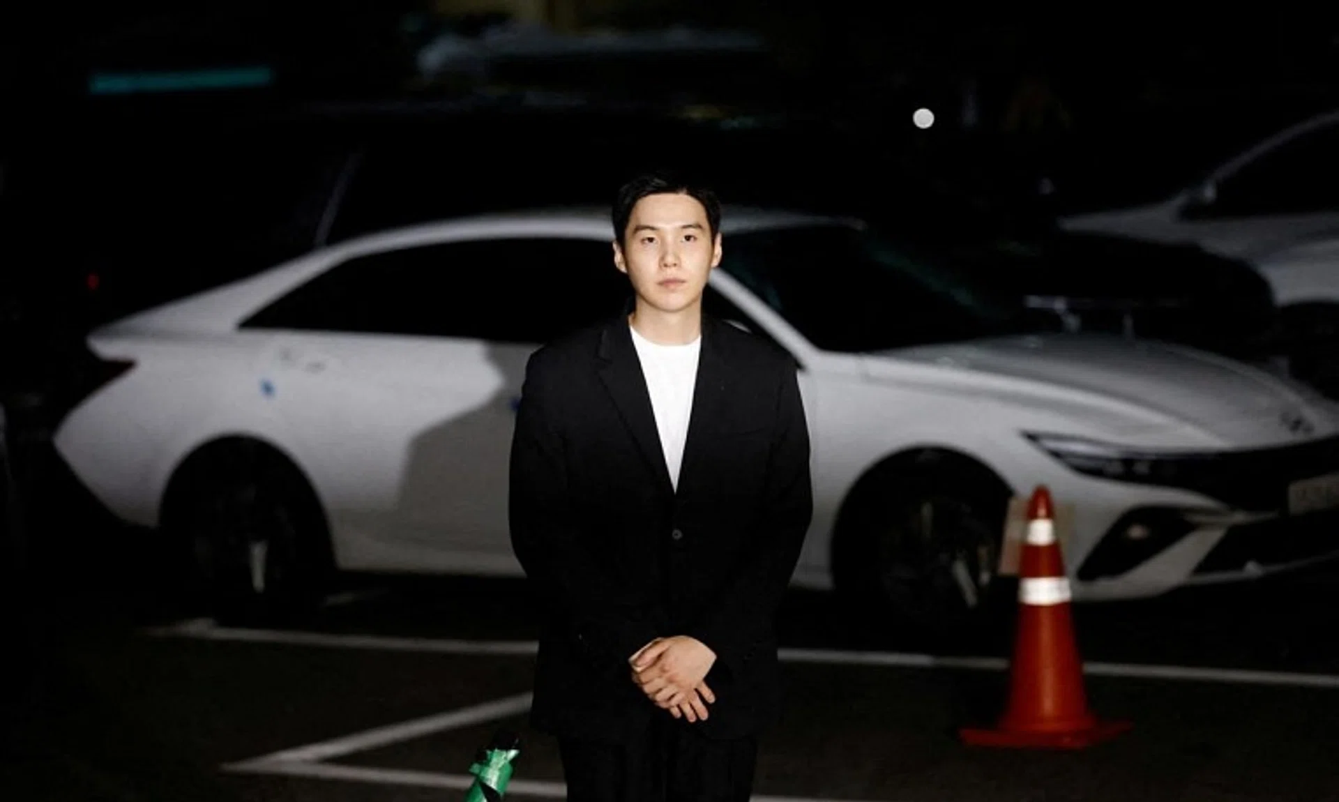 FILE PHOTO: Suga of the K-pop boy band BTS arrives at a police station for questioning regarding his drunk driving charge, in Seoul, South Korea, August 23, 2024. REUTERS/Kim Soo-hyeon/File Photo