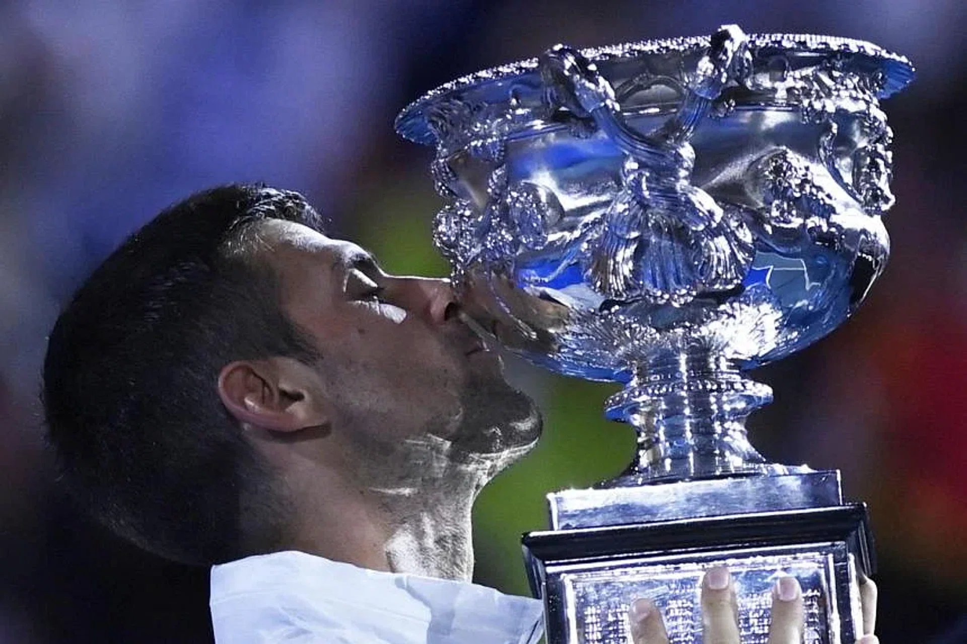 Serbia's Novak Djokovic celebrates with the trophy after winning his final match against Greece's Stefanos Tsitsipas. 