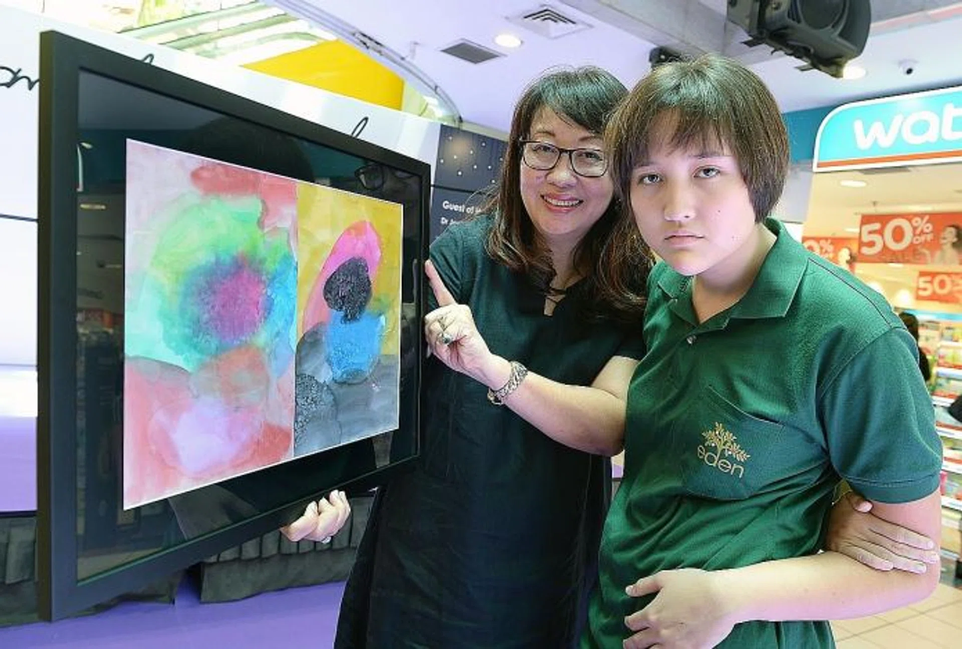 PASSION: Alexandra Ming, 15, and her mother, Mrs Marian Main, 56, with her winning entry Free To Express. 