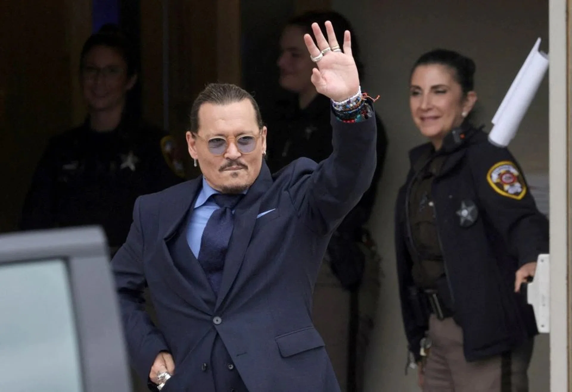 Actor Johnny Depp gestures as he leaves the Fairfax County Circuit Courthouse following his defamation trial against his ex-wife Amber Heard on May 27.