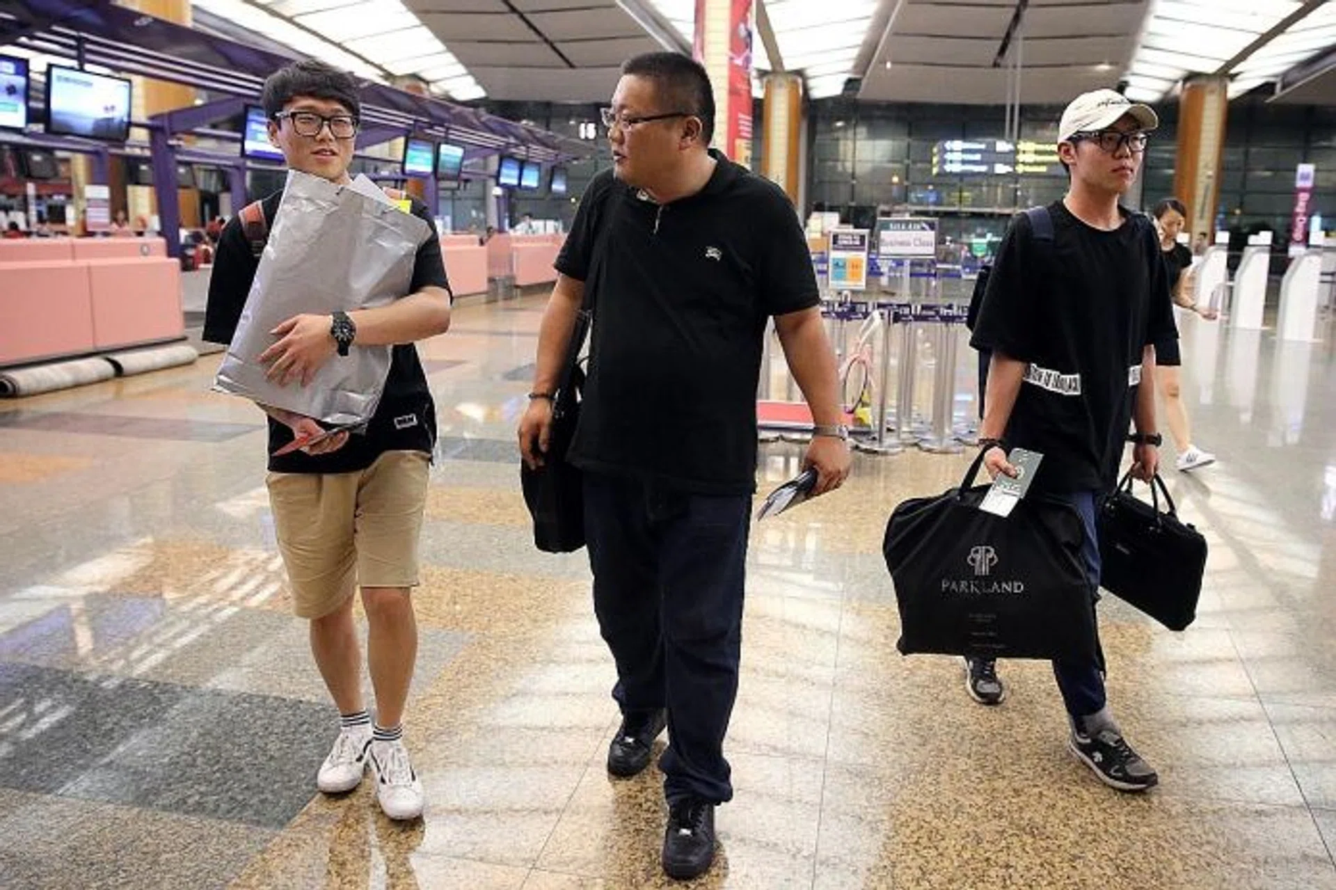 GOING HOME: (From left) Mr Byeon Dae Seung, Captain Kwon Do and Mr Kim Seon Kuk at Changi Airport.