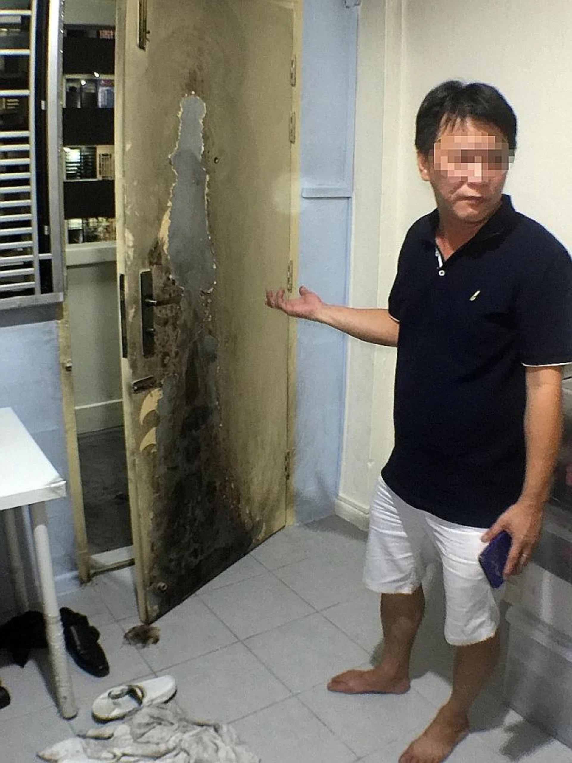 DESTRUCTION: The fire damaged Mr Richard Tan's front door and metal gates. Some shoes were also ruined.