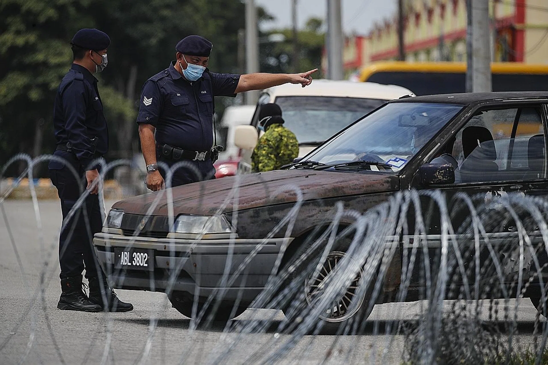 Malaysian police officers talking to residents at Sabak Bernam, Selangor, one of the states that has recorded a sharp increase in the number of daily infections of late. 