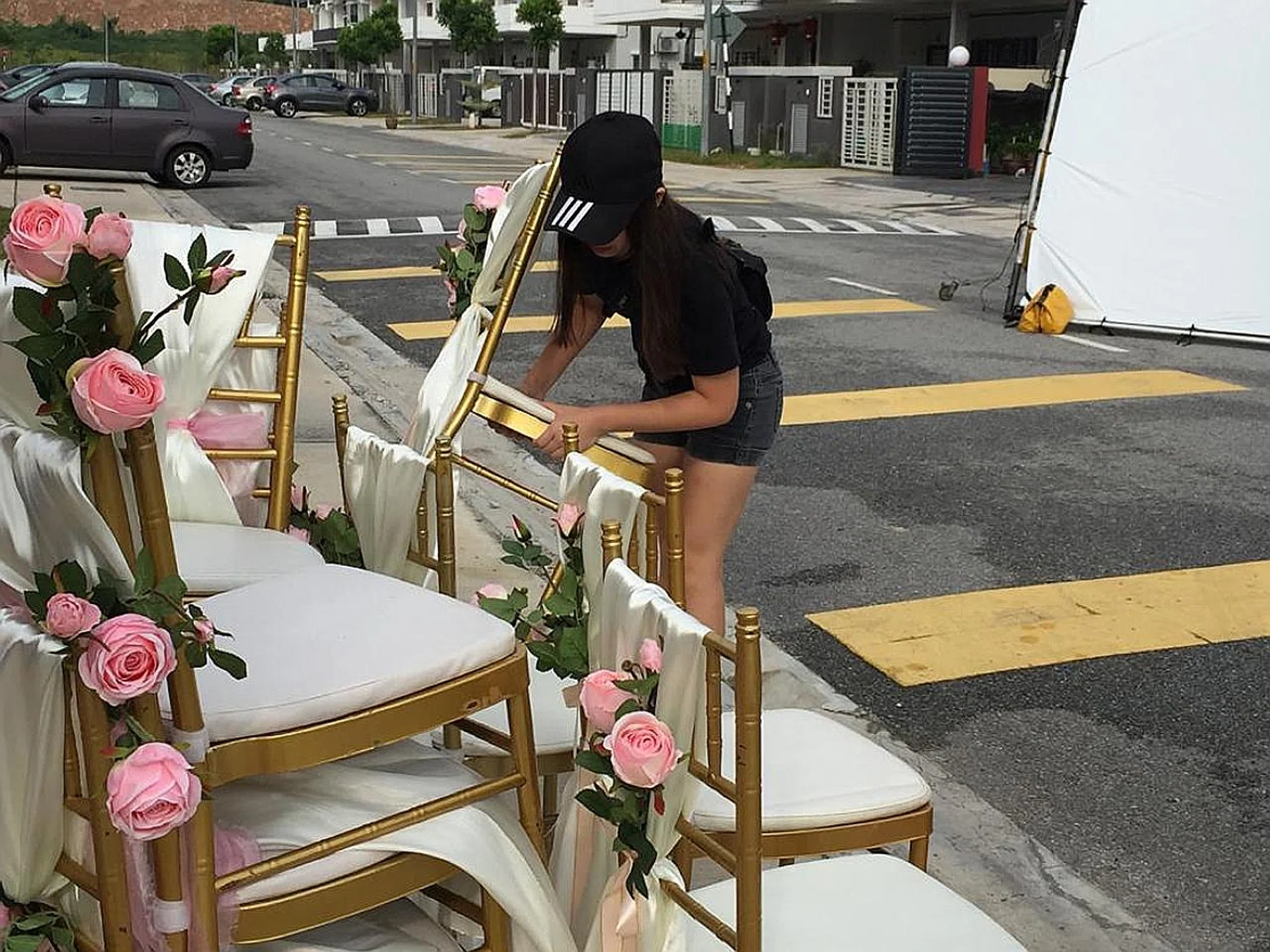 Miss Rachel Yat (above) arranging props on the set of The Big Day. 