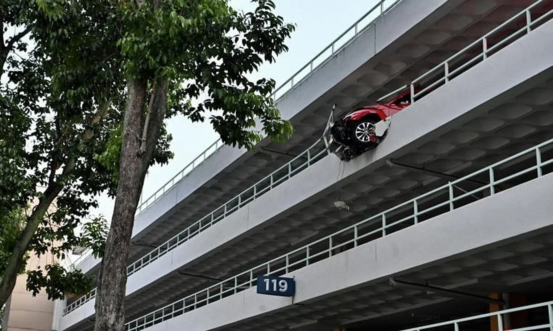 The car left hanging precariously over the edge at a multi-storey carpark in Bukit Merah on Nov 1. 