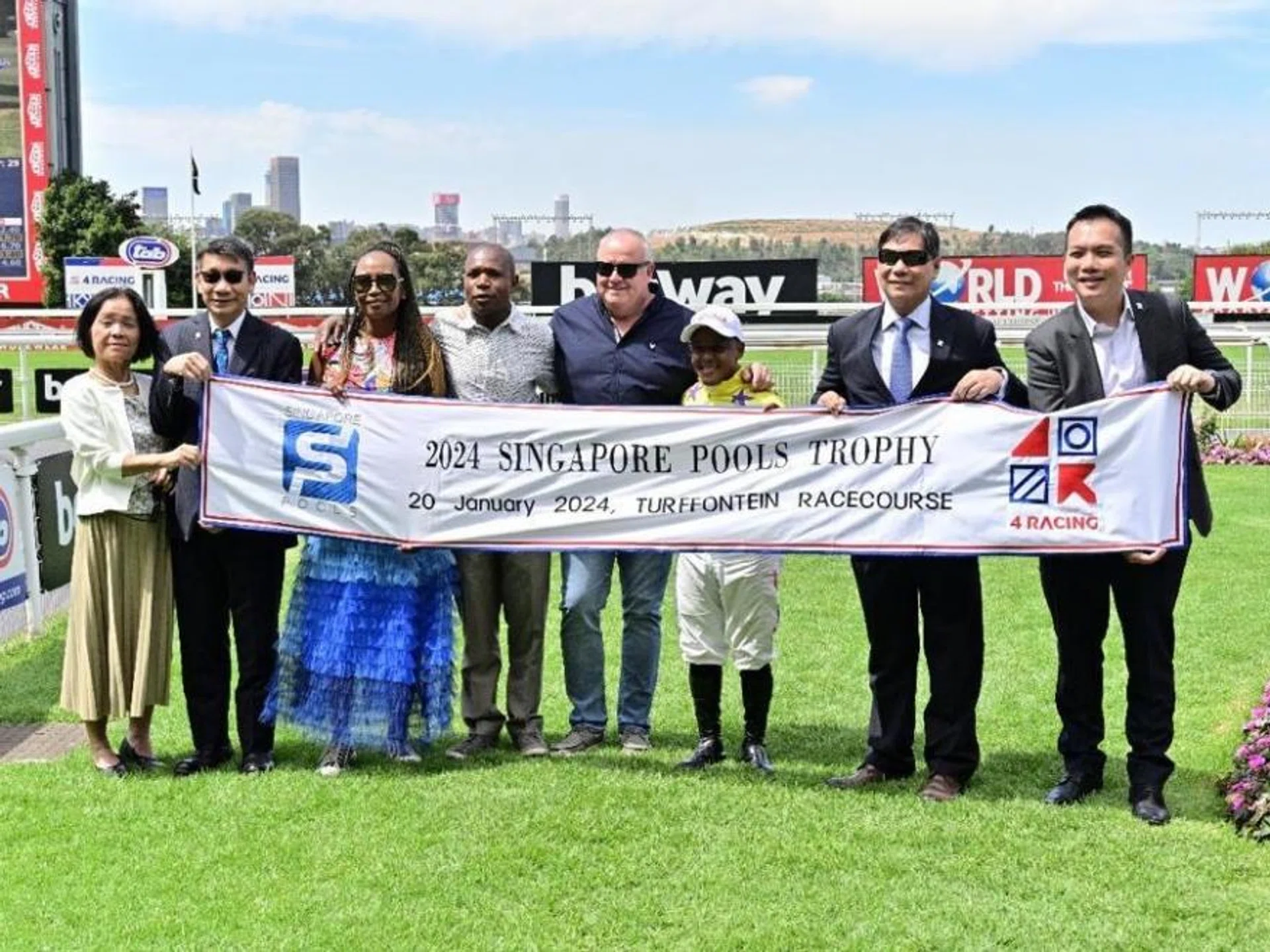 Pools' board director Lee Kwok Cheong (second from left) and wife, 4Racing CEO Fundi Sithebe, assistant trainer Vengi Masawi, trainer Mike de Kock, jockey Muzi Yeni, Pools' chief product officer Simon Leong and senior manager (product content) Steven Tan at Turffontein on Jan 20.
