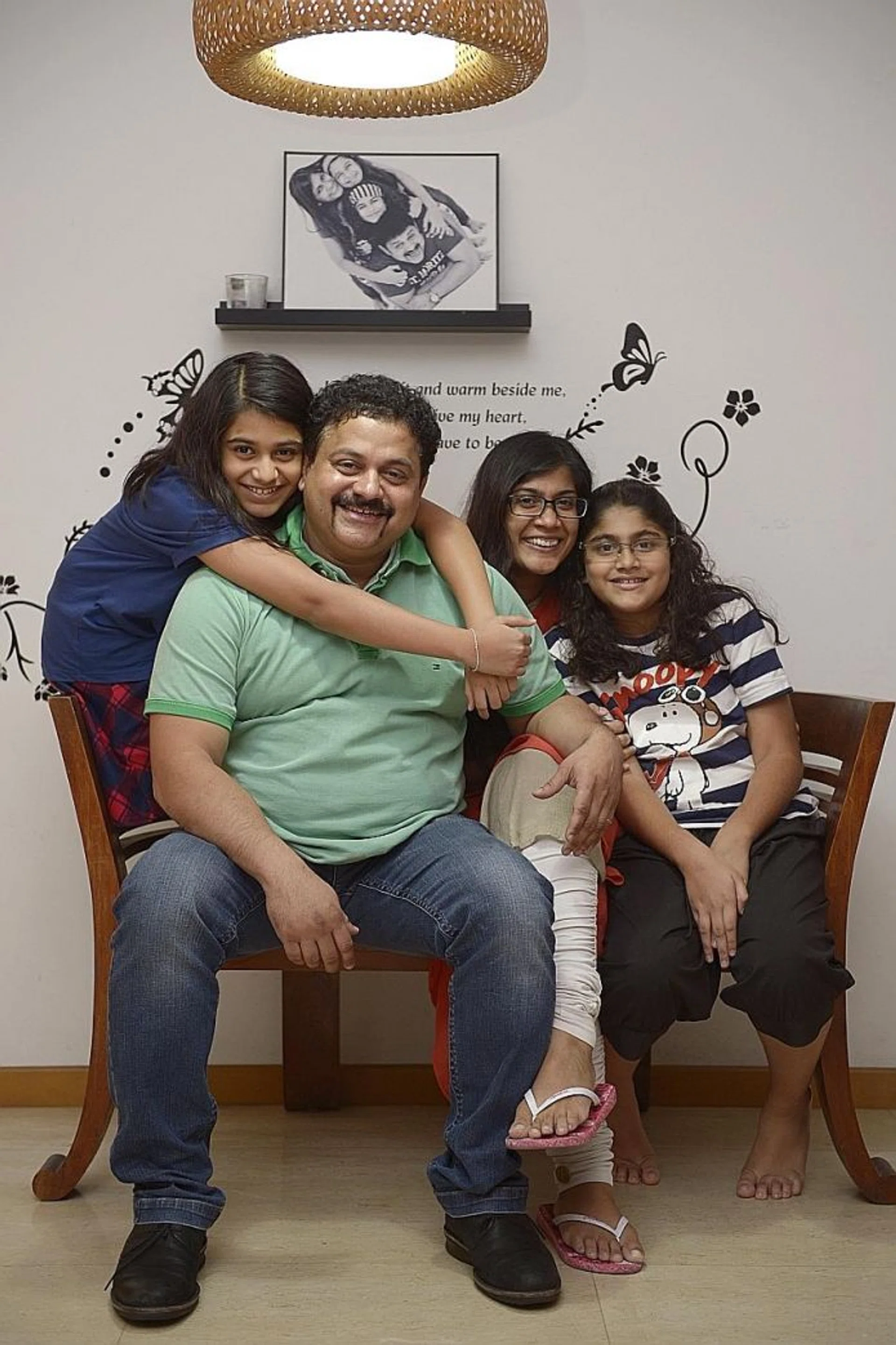 AT HOME: Mr Samir Salim Neji, pictured with his wife and daughters, became a citizen in 2004. He agrees with MP Darryl David's suggestion of additional assimilation requirements.