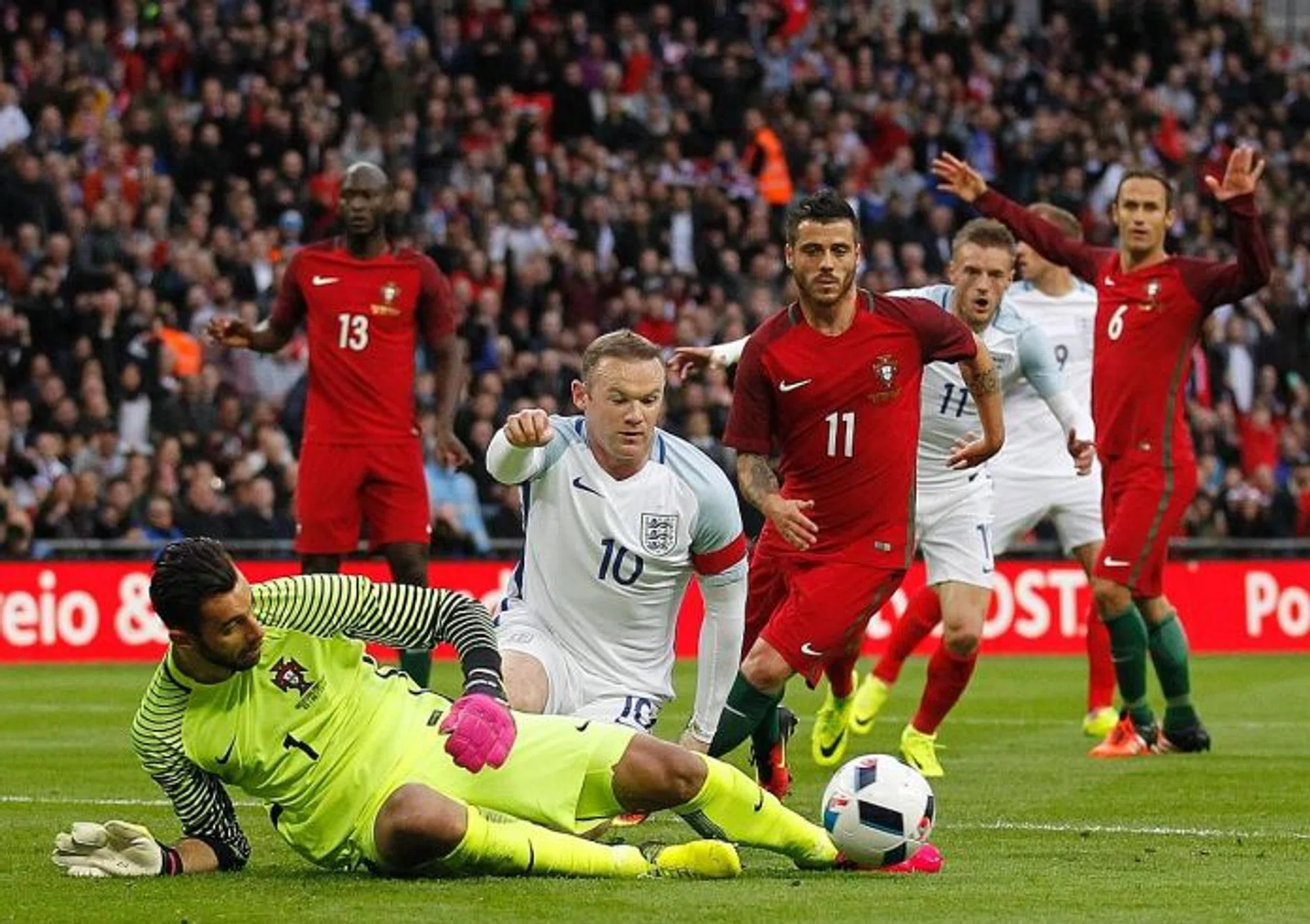 NO SMALL MATTER: Chris Smalling ensuring England go into Euro 2016 on a winning note after scoring the only winner in the friendly against Portugal. FOILED: Portugal goalkeeper Rui Patricio saving an attempt by Wayne Rooney (No. 10).  