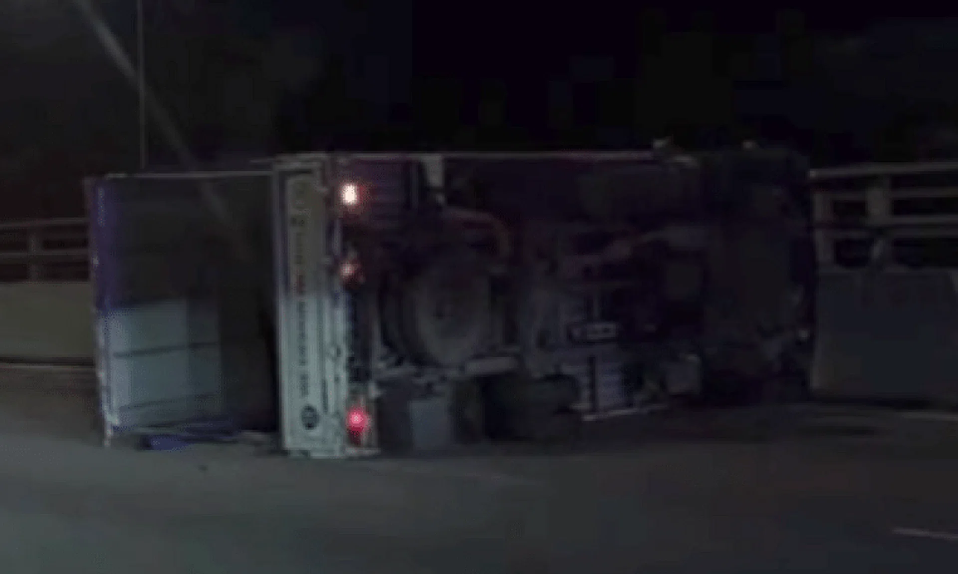 A lorry was seen overturned next to the road divider.