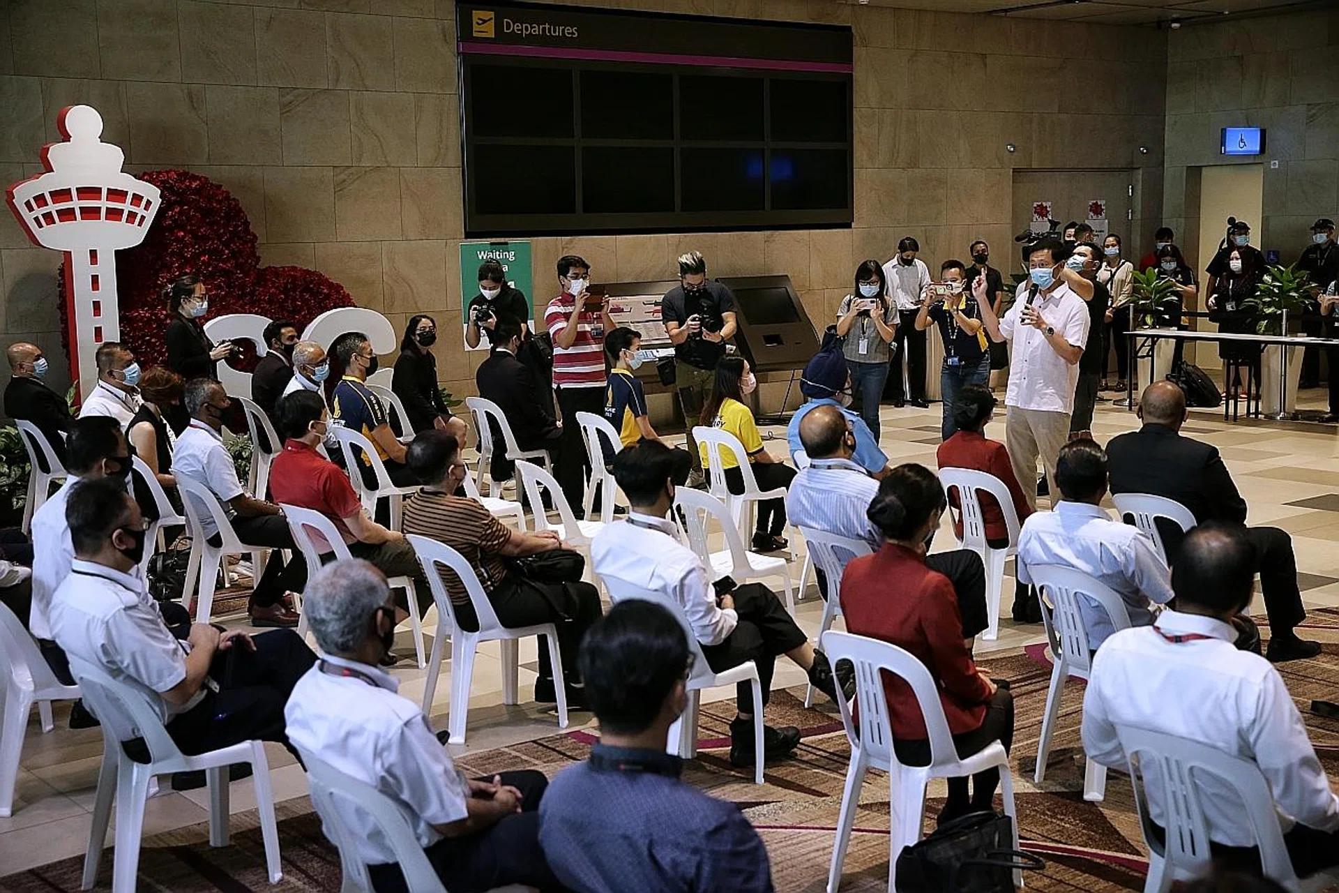 Transport Minister Ong Ye Kung interacting with front-line workers from the aviation industry who have registered for vaccination against Covid-19 at Changi Airport Terminal 4. 
