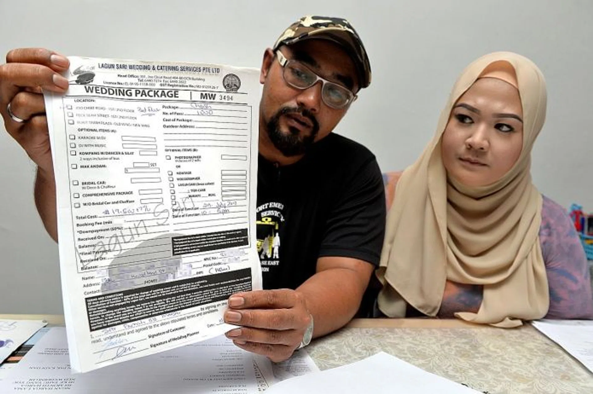 UPSET:Mr Muhammad Aslam and his fiancee, Ms Siti Fadilah, also believe they were issued fake receipts by Mr Sunato Zaidi.