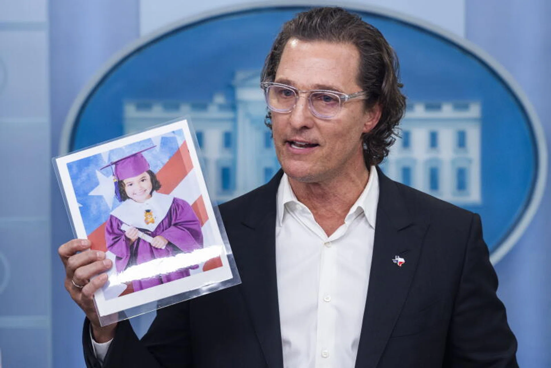 Actor Matthew McConaughey holds a picture of 10-year-old Uvalde school shooting victim Alithia Ramirez as he speaks to reporters at the White House.