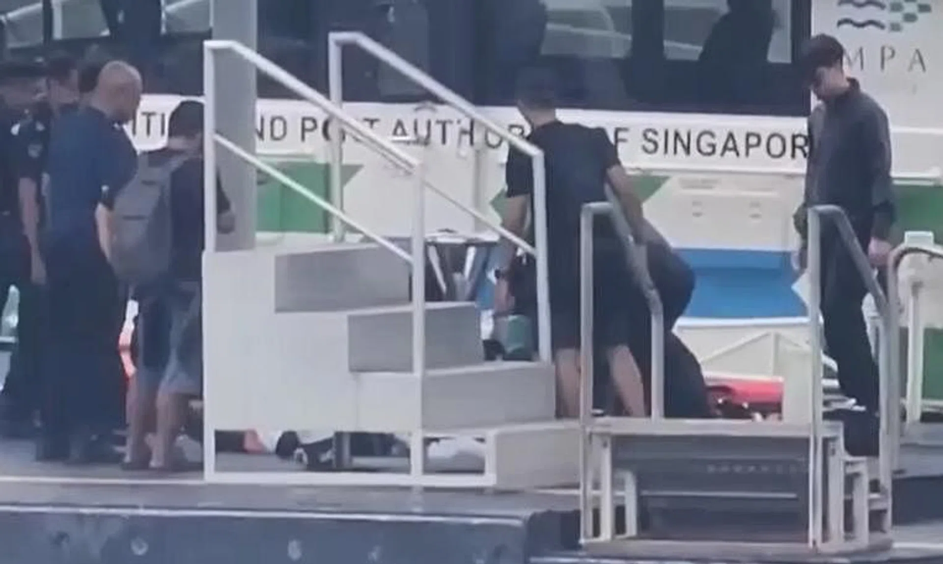 First aid being performed on the 22-year-old Malaysian diver at Marina South Pier. 