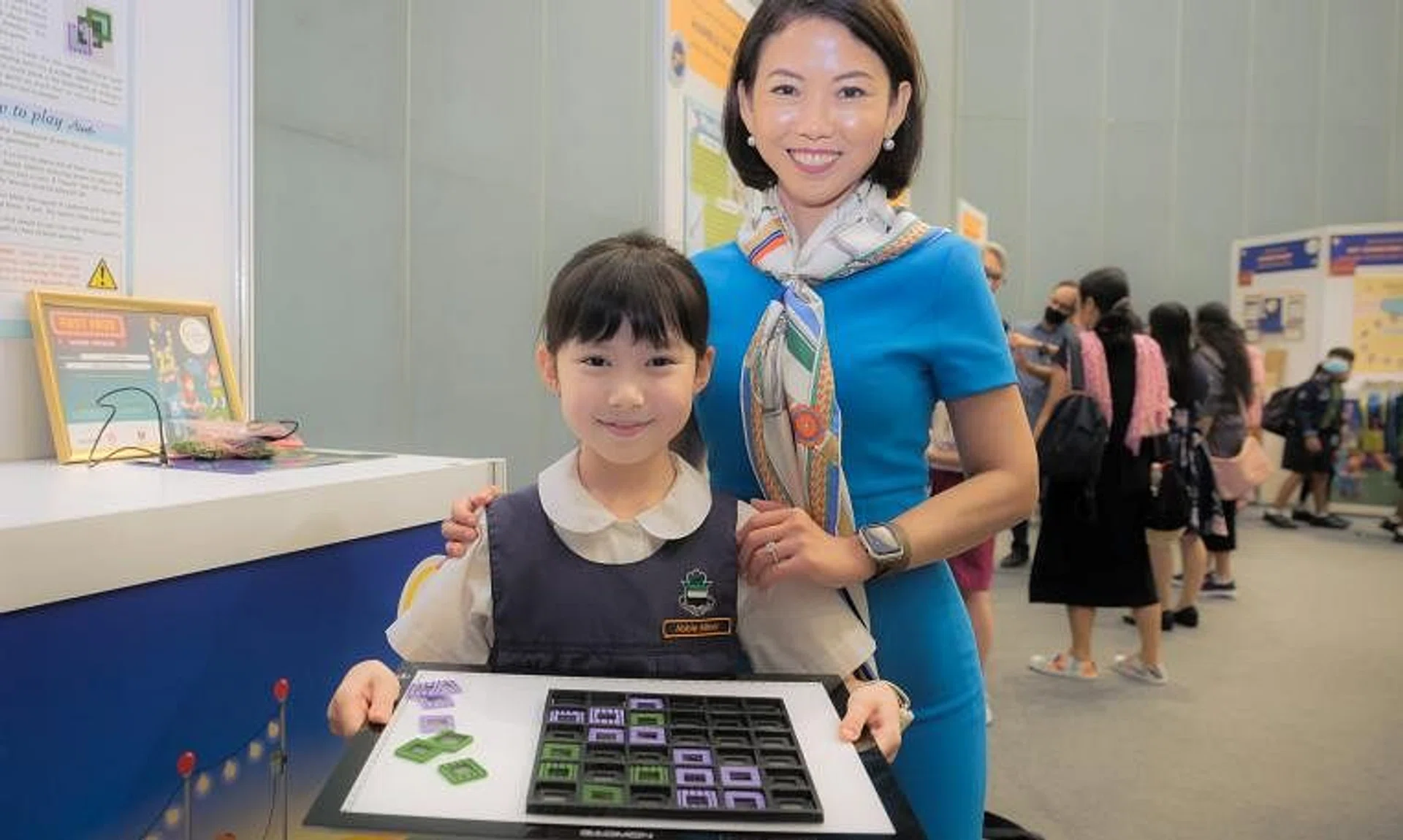 Raffles Girls’ Primary School pupil Abbie Milner with her mother and the 3D board game she created.