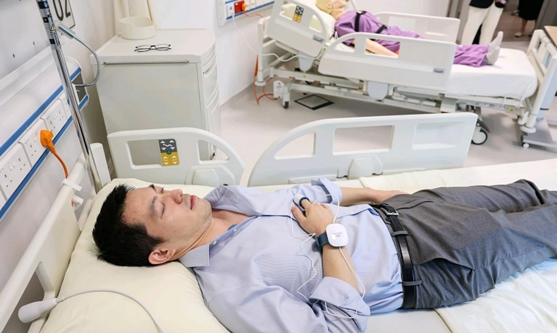 Eli Lilly's data manager Tao Liheng demonstrating a new sleep monitoring device at the drugmaker's Digital Health Innovation Hub.