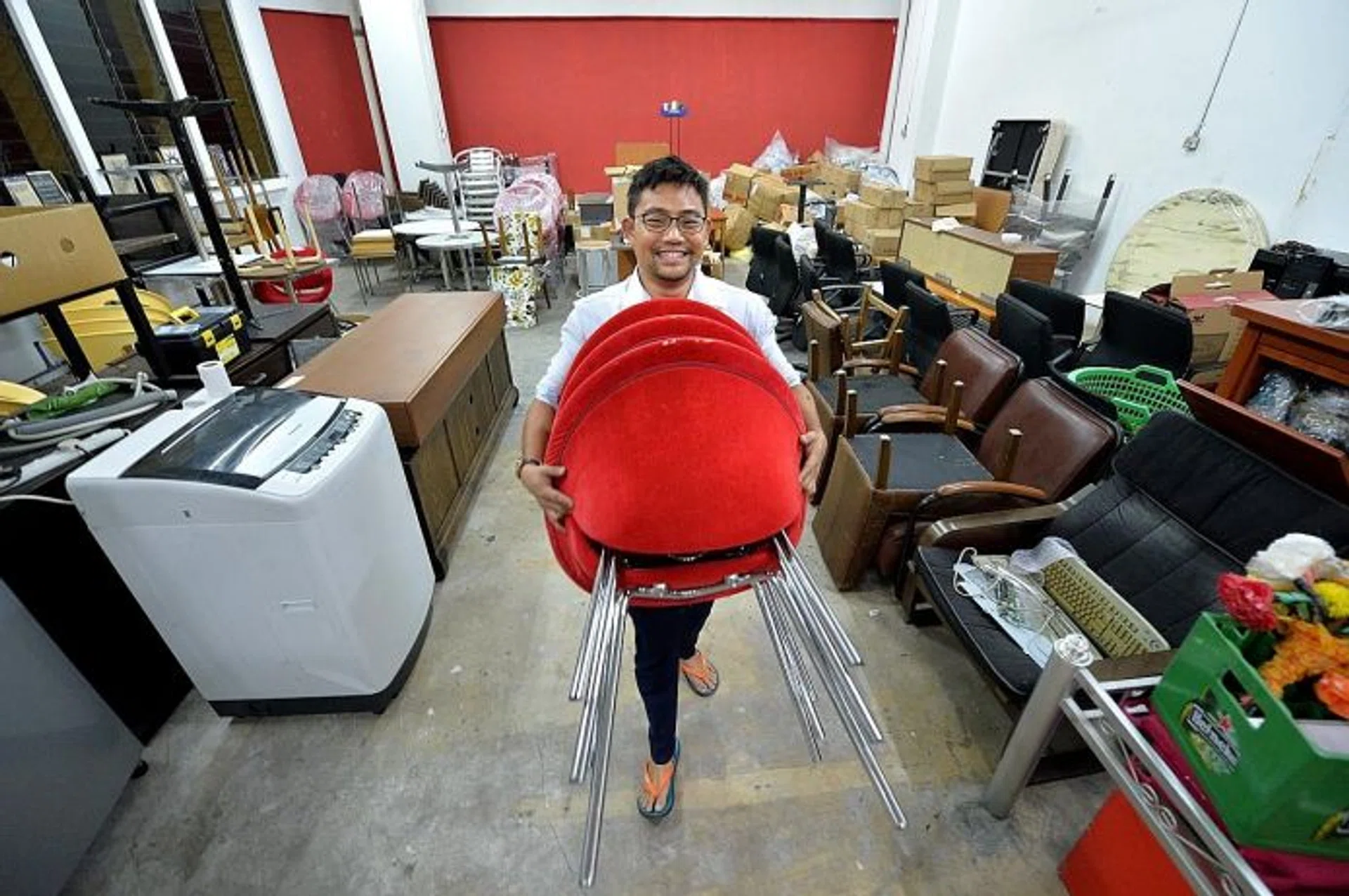 HANDS-ON: Mr Daniel Wong at his company's warehouse in Hillview Terrace.