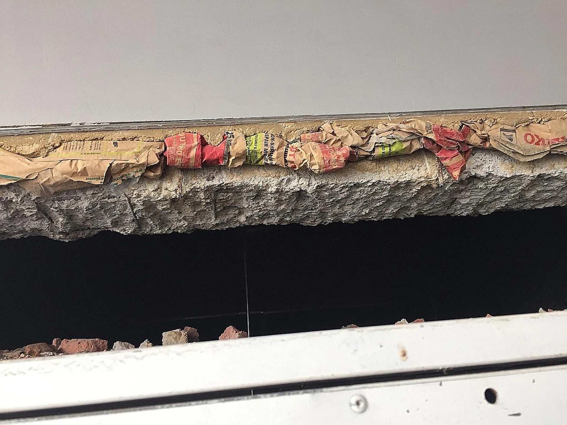 Brown cement bags and newspapers were found in the wall of a cargo lift landing at an industrial building in Ubi. 