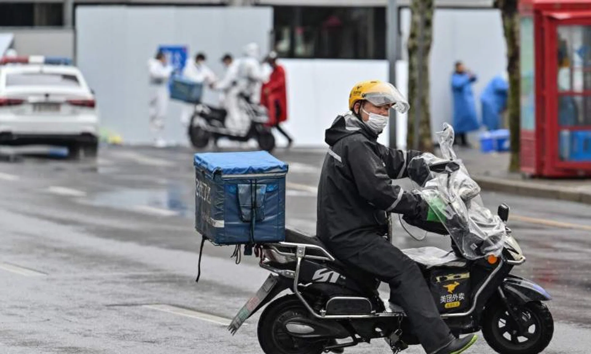 A delivery man rides a scooter to deliver an order in Shanghai on March 17, 2022.