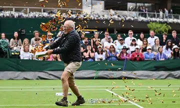 Wimbledon disrupted by climate change protesters; play halted as fans booed and jeered