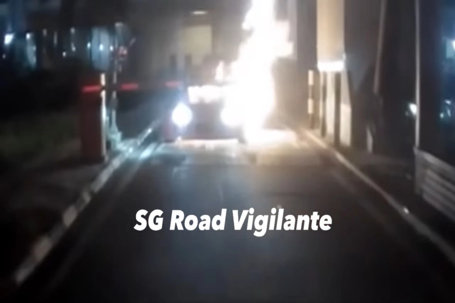 The video shows the car catching fire as it approaches the gantry.