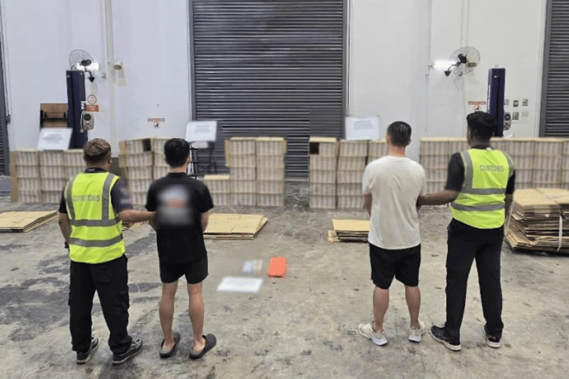 Two of the men arrested following enforcement operations by Singapore Customs on May 9 and 10.