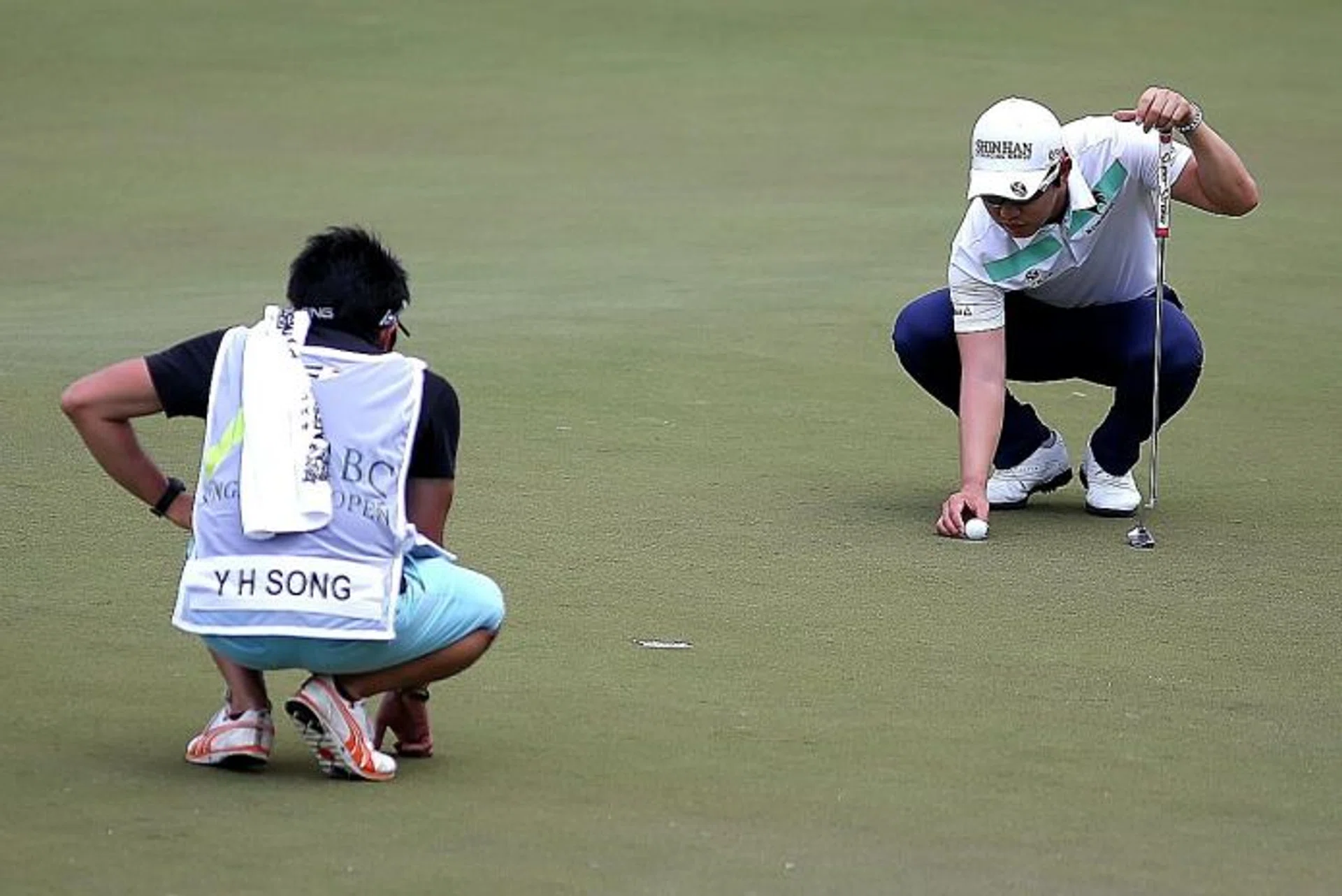 LEADERS: Song Young Han (above right) and Shintaro Kobayashi, who is a shot behind, are the frontrunners at the storm-hit SMBC Singapore Open.