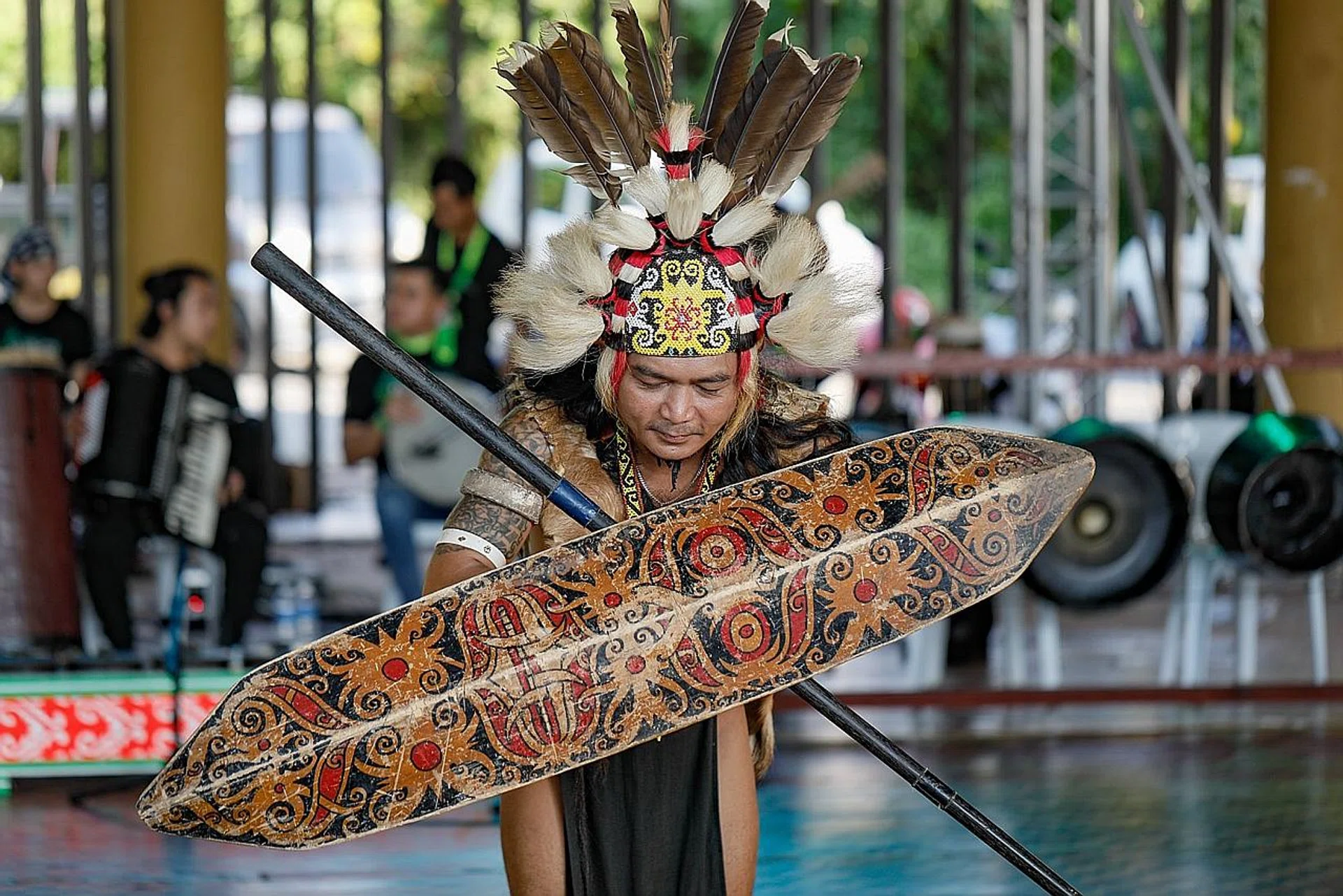 Grace Nono giving a performance of traditional chants and (above) the Orang Ulu Warrior Dance, with performers dressed in tribal outfits.