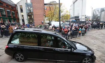 Thousands line Manchester streets to bid final farewell to Bobby Charlton