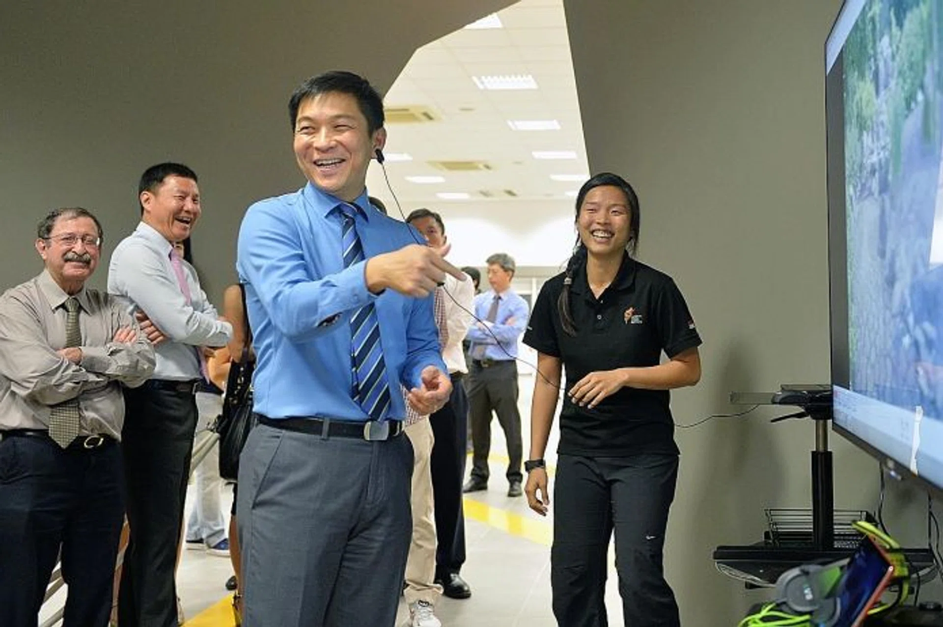 IT'S OFFICIAL: Minister for Social and Family Development and Singapore National Olympic Council president Tan Chuan-Jin (centre) on a tour around the National Youth Sports Institute yesterday.