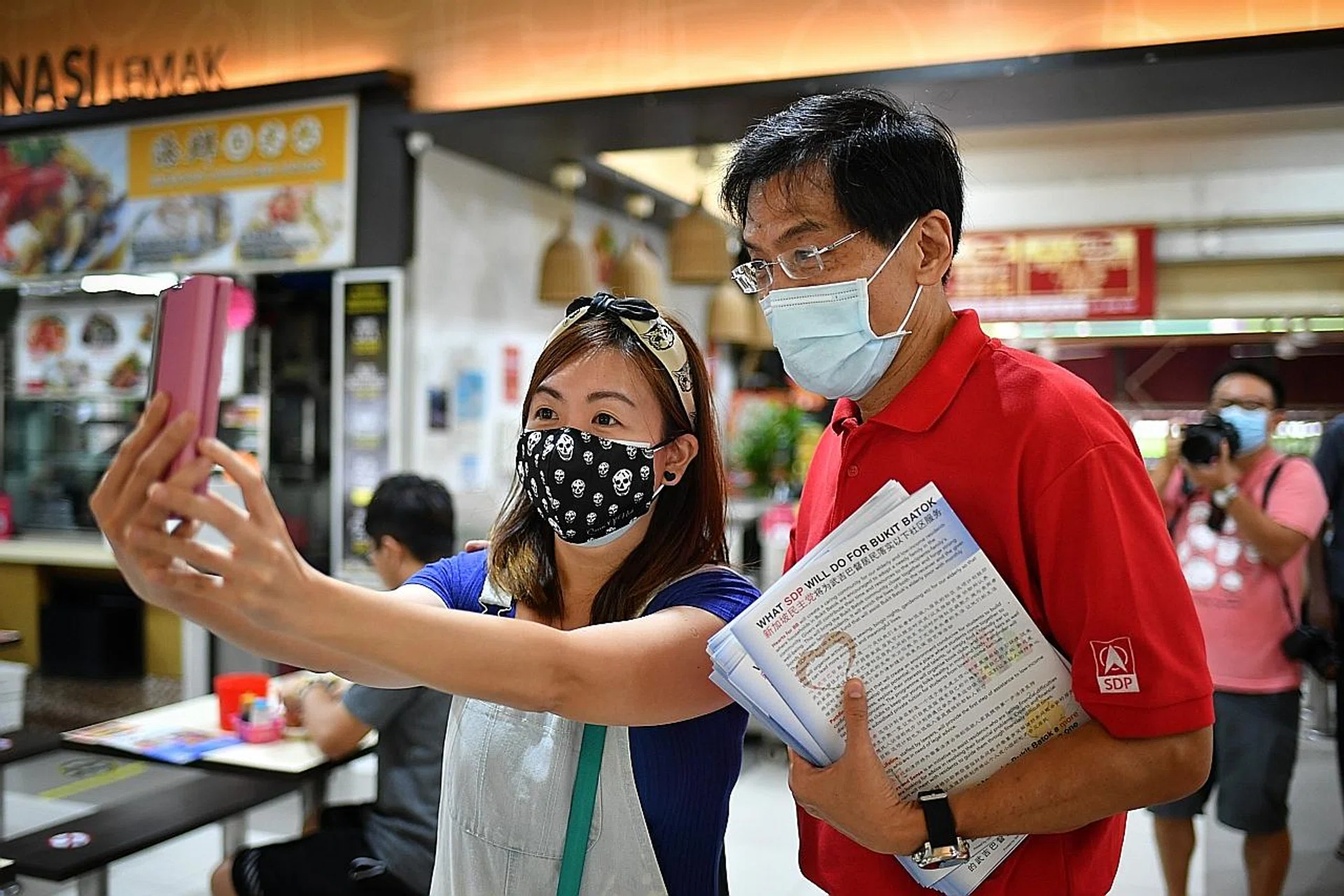 A woman taking a selfie with SDP chief Chee Soon Juan at Bukit Batok Central yesterday. 