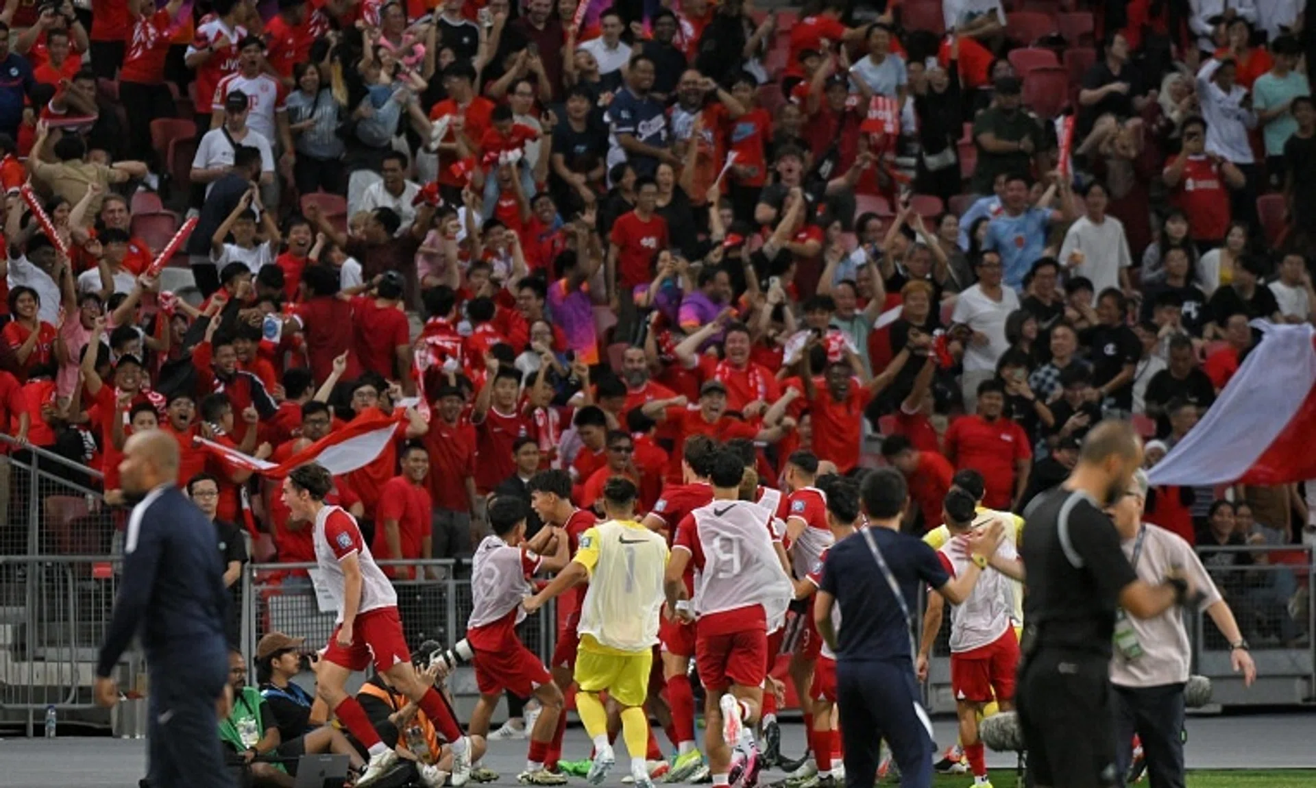 The Singapore football squad celebrating in front of the home fans after scoring the equalising goal against China during the World Cup 2026 and Asian Cup 2027 R2 qualifiers held at the National Stadium on March 21, 2024.