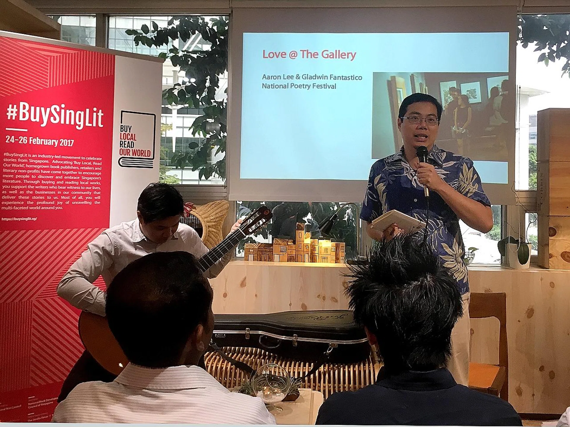 Mr Aaron Lee reading two of his poems yesterday, Play It By Ear and Longing, as a preview for his reading on Feb 25 at the National Gallery. 